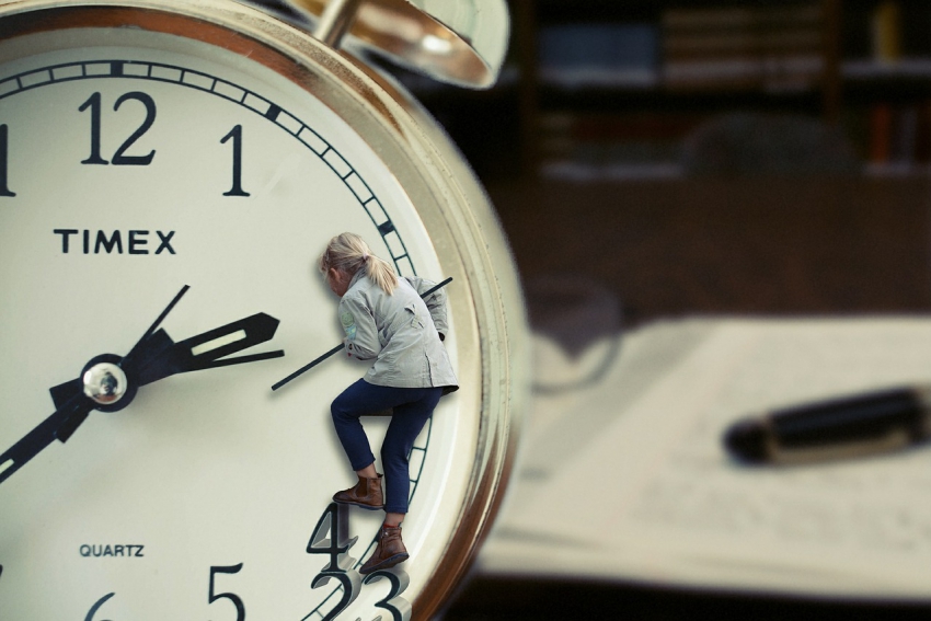 A clock and a busy desk, time management
